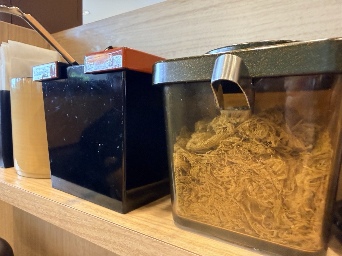 資さんうどんの無料セルフトッピング（とろろ昆布と揚げ玉）の容器